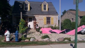 Pink car split in half and other assorted pieces form the landscape of a resident's front yard along South Lake Drive in Milwaukee.